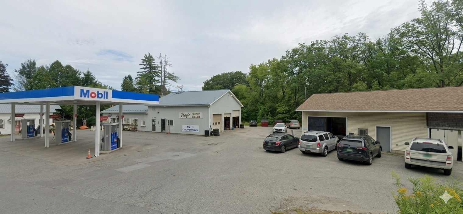 Parking lot view of Hay's Service Station and neighboring service buildings.